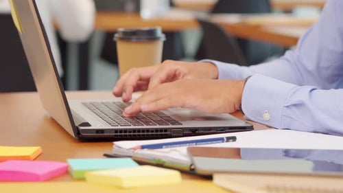Close Up of Person Typing on Laptop at Desk