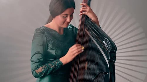 Woman plays a stringed musical instrument