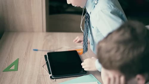 Children Studying with Tablet Device at Home