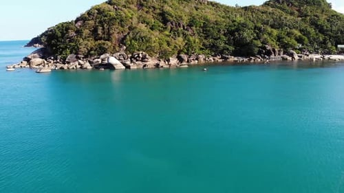 Boat Near Tropical Shore. Amazing Drone View of Modern Yacht Sailing on Calm Sea Water Near Coast