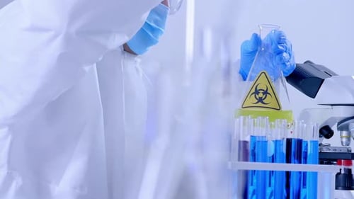 Scientist in Protective Suit Working in Laboratory