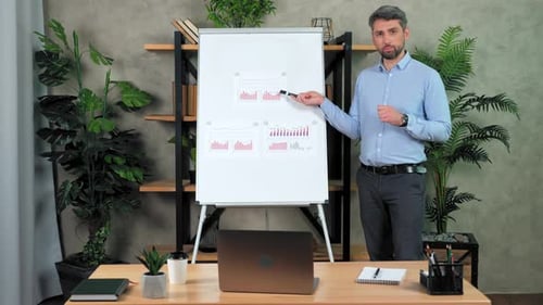 Man teacher teaches students remote videocall points marker diagram on flipchart