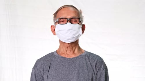 Senior Adult Wearing Protective Face Mask and Glasses