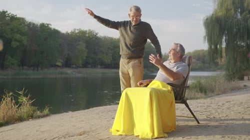Men Talking by the Lake on Sunny Day