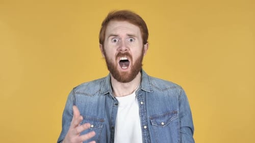 Unhappy Redhead Man Reacting to Failure and Problems Yellow Background