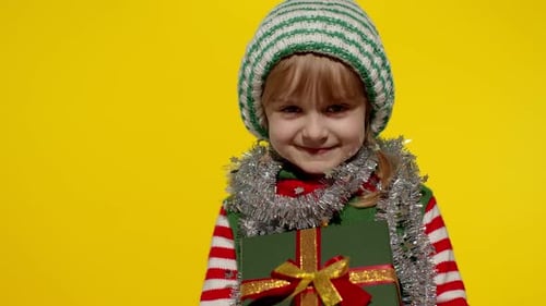 Smiling Child Holding Christmas Gift