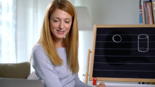 Woman Teaches Shapes Online with Chalkboard