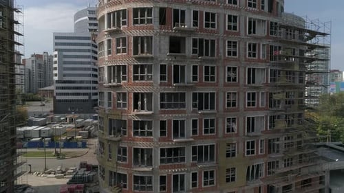 Aerial shot of construction of high-rise apartment building in city