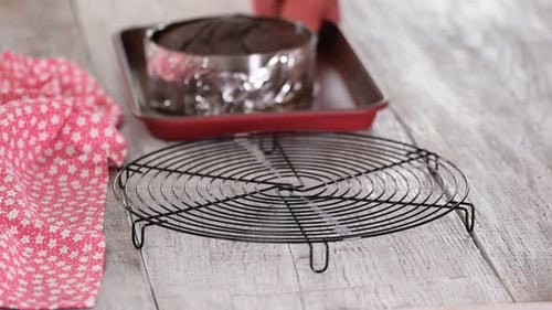 Placing Freshly Baked Chocolate Cake on Cooling Rack