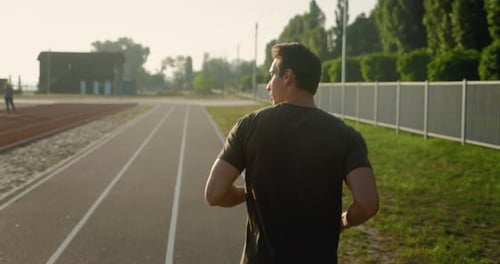 Rear View of Sport Man Running Outdoors