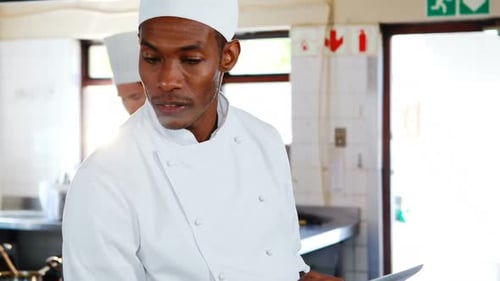 Chef using digital tablet in kitchen