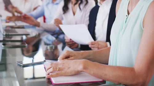 Professional businesspeople clapping together in meeting room in modern office in slow motion