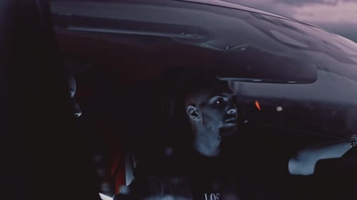 Man and Woman Riding in Car at Night