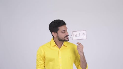 Young Happy Bearded Indian Businessman with Selfie Paper Sign