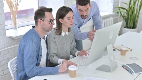 Team Collaboration on Desktop Computer in Bright Office