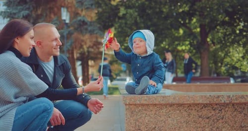 Happy Parents and Her Little Child Playing Together Outdoor Having Fun in the Park