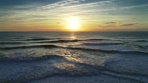 Aerial View on Big Ocean Waves and Sunset Sun