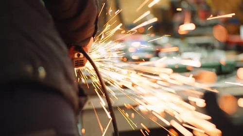Angle Grinder Cutting Metal at Workshop