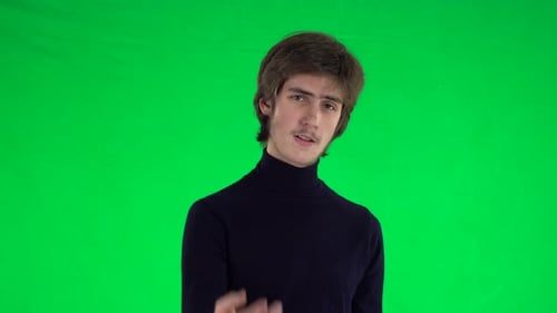 Portrait of Tall Slender Young Guy with Thick Hair Is Waving Hand and Showing Gesture Come Here on a