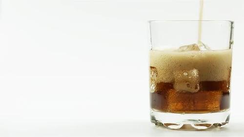 Refreshing Brown Soda Poured into Glass with Ice