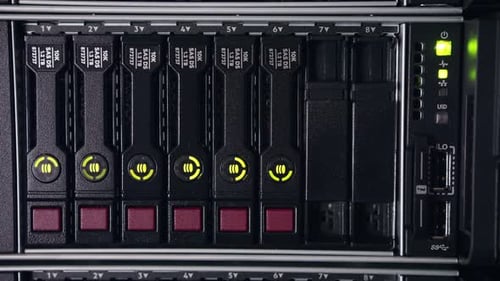 Close up shot of data servers with ethernet cables and blinking hard drive lights