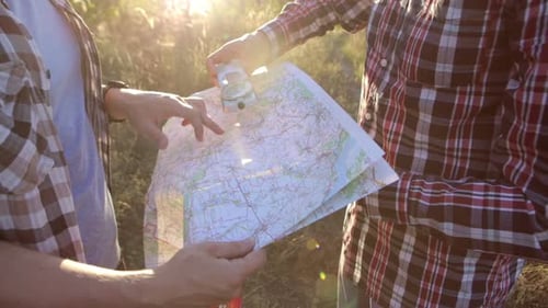Men Exploring Nature with Map and Compass