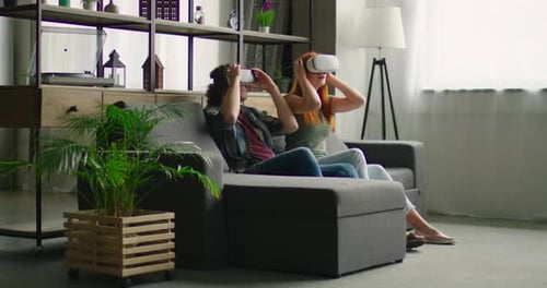 Couple Experiencing Virtual Reality on Couch at Home