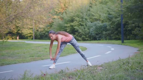 Woman Runner Stretching Arms Before Running Summer Park
