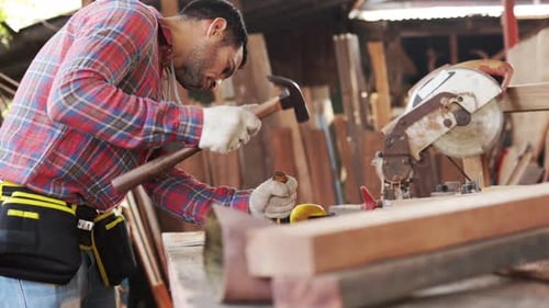 Focused Carpenter Crafting Wood in Workshop