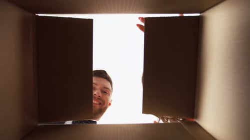 Happy Couple Receives Gift in Cardboard Box