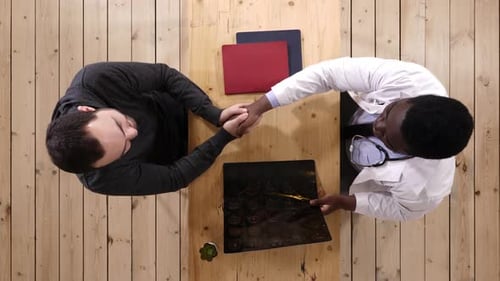 Doctor Showing X-ray to Patient in Office