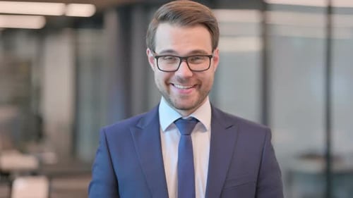 Man Smiling in Blue Suit and Tie at Work