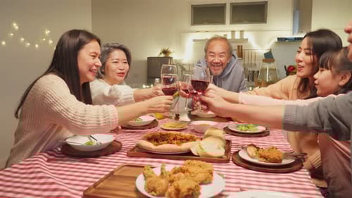 Family Dinner Toasting Glasses at Home Table