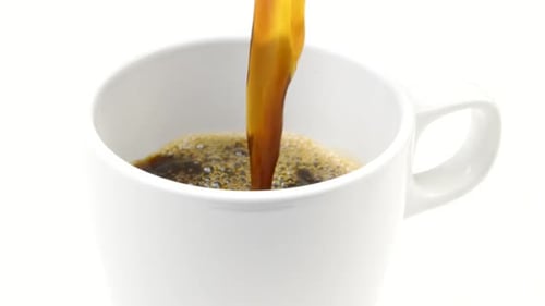 Coffee Pouring into White Mug in Close Up
