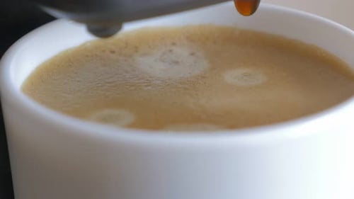 Close Up of Coffee Pouring Into a Mug