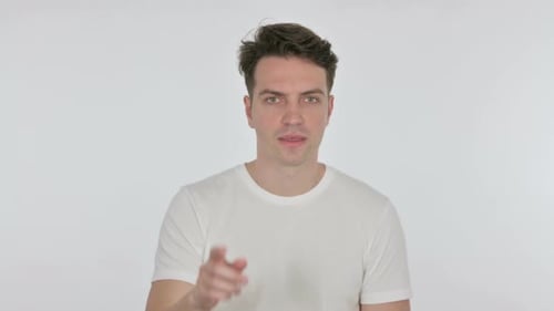 Happy Young Man Pointing at the Camera on White Background