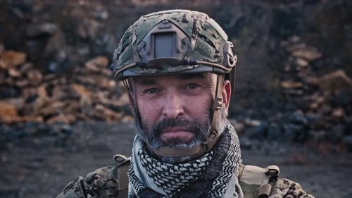 Intense Soldier Stares in Rocky Landscape
