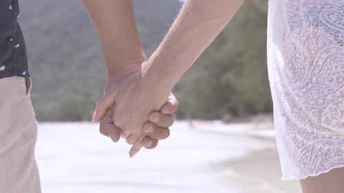 Couple Holding Hands on Beach