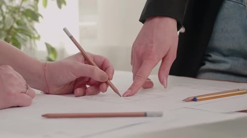 Architects Reviewing Blueprint in a Workplace