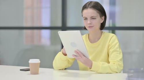 Young Woman Using Tablet While Sitting in Office