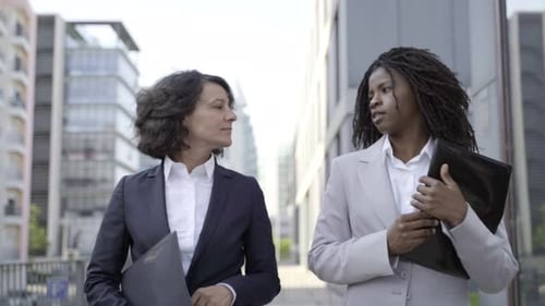 Business Women Walking and Talking in City