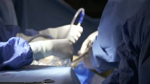 Surgeons working during surgery, close up on hands and instruments.