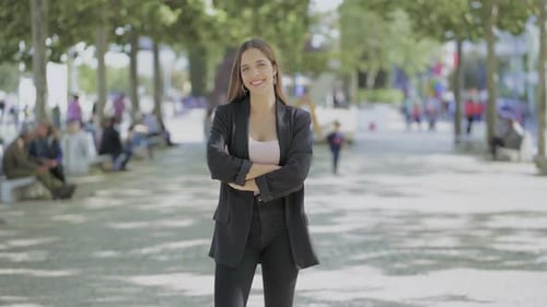 Confident Woman Posing in a Sunny Urban Park