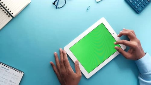 Top View of Businessman Using Digital Tablet on Blue Background