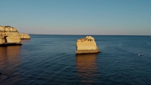 Drone out over cliff on sunset