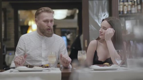 Portrait of a Beautiful Young Couple Dining in a Cafe or Restaurant. Partners Communicate While
