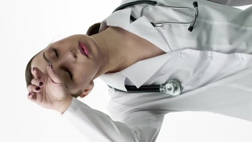 Tired Doctor Rubbing Face and Eyes