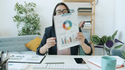 Young Woman Delivering a Business Presentation at Desk