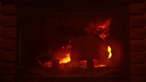 Fireplace With Burning Logs and Flickering Flames