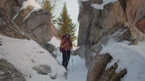 Bearded Hiker Trekking Through Snowy Mountain Pass